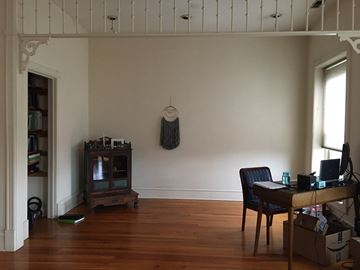Chicago apartment for rent - a living room with a wooden floor and a desk and a tv