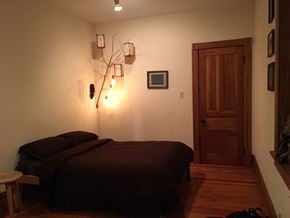 Chicago apartment for rent - a bedroom with a bed and a wooden door