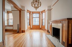 Chicago apartment for rent - an empty living room with wood floors and a fireplace
