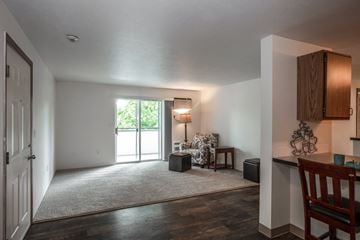 Spokane Valley apartment for rent - a living room with a rug and a door to a balcony