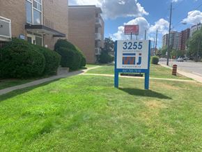 Toronto apartment for rent - a gas station sign in the grass in front of a building