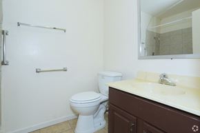 Las Vegas apartment for rent - A white toilet sits in a bathroom next to a sink.