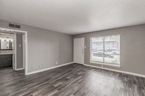 Dallas apartment for rent - Open-concept living room with wood-style flooring at Chapel Creek Apartments Dallas