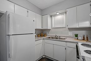 Victoria apartment for rent - Kitchen with white cabinetry, tile flooring, and breakfast bar