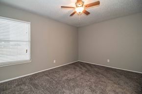 Hurst apartment for rent - Bedroom with ceiling fan and plush carpet flooring at Verano Oaks Apartments