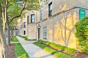 Oak Park apartment for rent - A brick building with a green sign that says "Oak Park" on it.