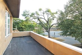 Oak Park apartment for rent - a balcony with a view of trees and a parking lot