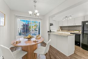 Casselberry townhouse for rent - A kitchen with a table and chairs in front of a window.