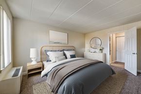 Laurel apartment for rent - A bedroom with a large bed and a window.