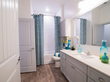 Spacious bathrooms with wood-framed mirrors