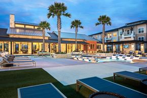 San Antonio apartment for rent - Upscale pool deck offering in-water relaxation areas, ample lounge seating, and a sophisticated resort atmosphere.