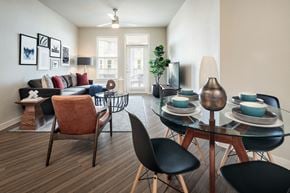 San Antonio apartment for rent - Bright open-concept living and dining area with contemporary furnishings, large windows, and access to a private balcony.