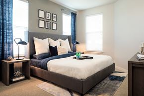 San Antonio apartment for rent - Spacious bedroom featuring large windows, plush carpeting, and contemporary finishes for a comfortable retreat.