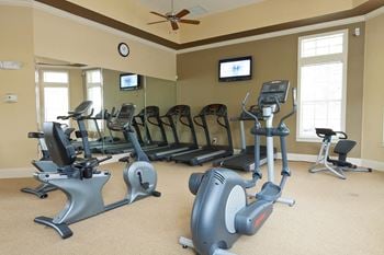 Fitness center with cardio equipment and televisions