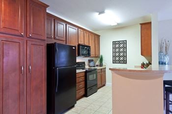 Kitchen with breakfast bar and black appliances