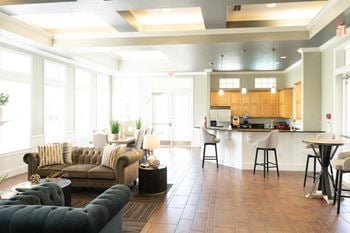 Clubhouse with tufted sofas and kitchen bar