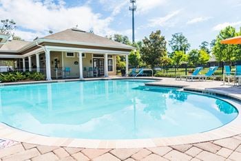 Sparkling pool with poolside cabana and lounge seating