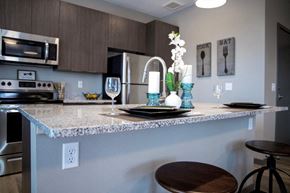 Loveland apartment for rent - A kitchen with a granite countertop and a stainless steel refrigerator.