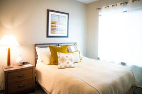Loveland apartment for rent - A bedroom with a bed, nightstand, and a picture on the wall.