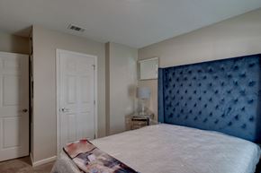 Beaufort apartment for rent - a bedroom with a large bed and a blue headboard