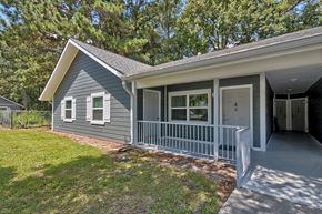 Beaufort apartment for rent - a small gray house with a porch and a grass yard