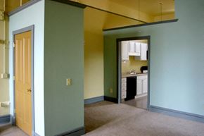 Oshkosh apartment for rent - an empty living room with a kitchen in the background