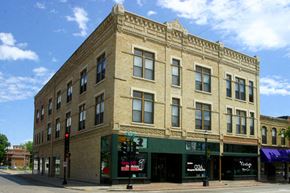 Oshkosh apartment for rent - a large brick building on the corner of a city street