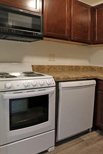 Oshkosh apartment for rent - a kitchen with white appliances and a granite counter top