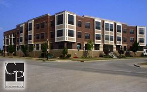 Oshkosh apartment for rent - a large brick building with a street in front of it