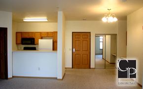 Oshkosh apartment for rent - an empty room with a kitchen and a door to a living room