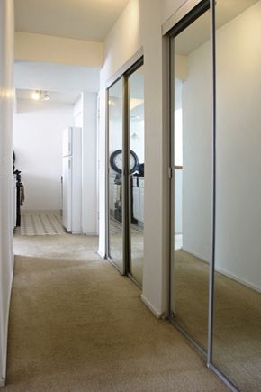 Oshkosh apartment for rent - a hallway with mirrors on the wall and a carpeted floor