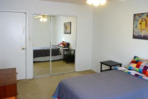 Oshkosh apartment for rent - a bedroom with a bed and a mirrored closet