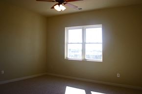 Oshkosh apartment for rent - a living room with a window and a ceiling fan