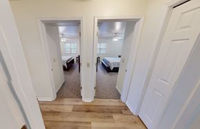 Oshkosh apartment for rent - a bedroom with two closets and a door to a room with beds