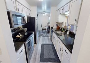 Oshkosh apartment for rent - a kitchen with black counter tops and white cabinets