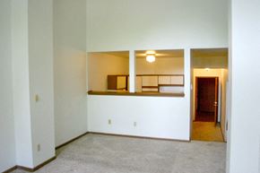 Appleton apartment for rent - an empty living room with white walls and a kitchen