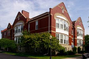 Appleton apartment for rent - a large brick building with trees in front of it