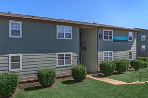 Columbia apartment for rent - an exterior view of a home with a lawn and shrubs