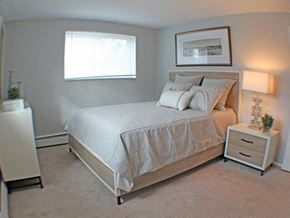 Parma Heights apartment for rent - a bedroom with a bed and a window  at Valley York Apartments, Ohio
