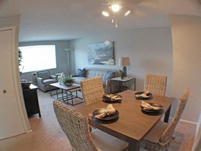 Parma Heights apartment for rent - a dining room with a table and chairs and living room in the background  at Valley York Apartments, Ohio