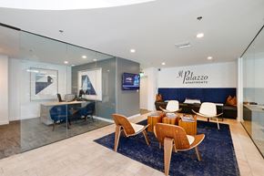 San Diego apartment for rent - A modern living room with a glass wall and a blue rug.