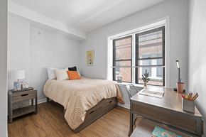 Philadelphia apartment for rent - Spacious furnished student apartment bedroom with large windows, vinyl hardwood floors, and white walls