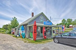Westport apartment for rent - a building with surfboards outside of it and a car parked in front
