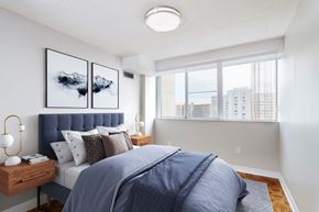 Mississauga apartment for rent - a bedroom with a bed and a large window