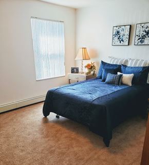 Detroit apartment for rent - a bedroom with a bed and some pillows on it