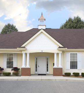 Pontiac townhouse for rent - the front of a yellow house with white pillars and a white door