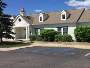 Ann Arbor townhouse for rent - a parking lot in front of a white house