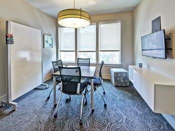Echo apartments meeting room with whiteboard and tv