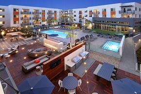 Orange apartment for rent - Resort-style pool with surrounding apartment buildings at Eleven 10 in Orange, CA