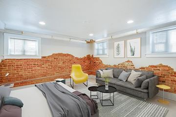 Denver apartment for rent - a living room with a brick accent wall and a couch